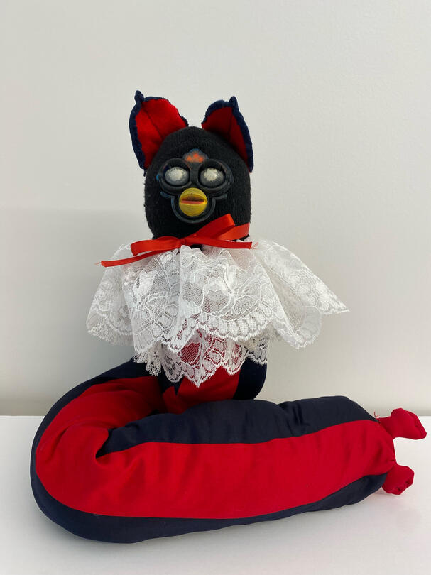 Long furby made using 3d printing, a ball jointed spine, and sewn together fabrics.